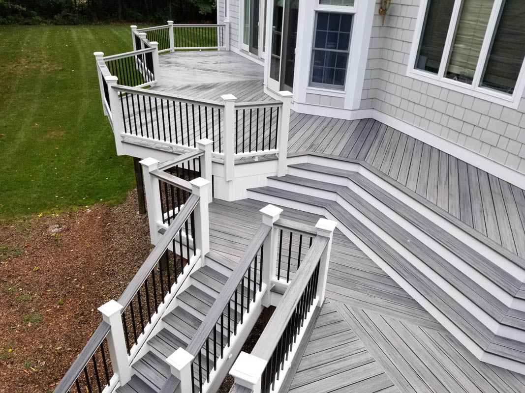 Trex Multi-level deck, Island Mist, White Railing w/black aluminum balusters, Cocktail style assembly, 2x6 cap board, 6x6 post sleeves.